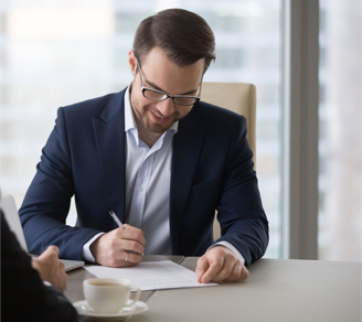 Man signing contract after meeting with colleague